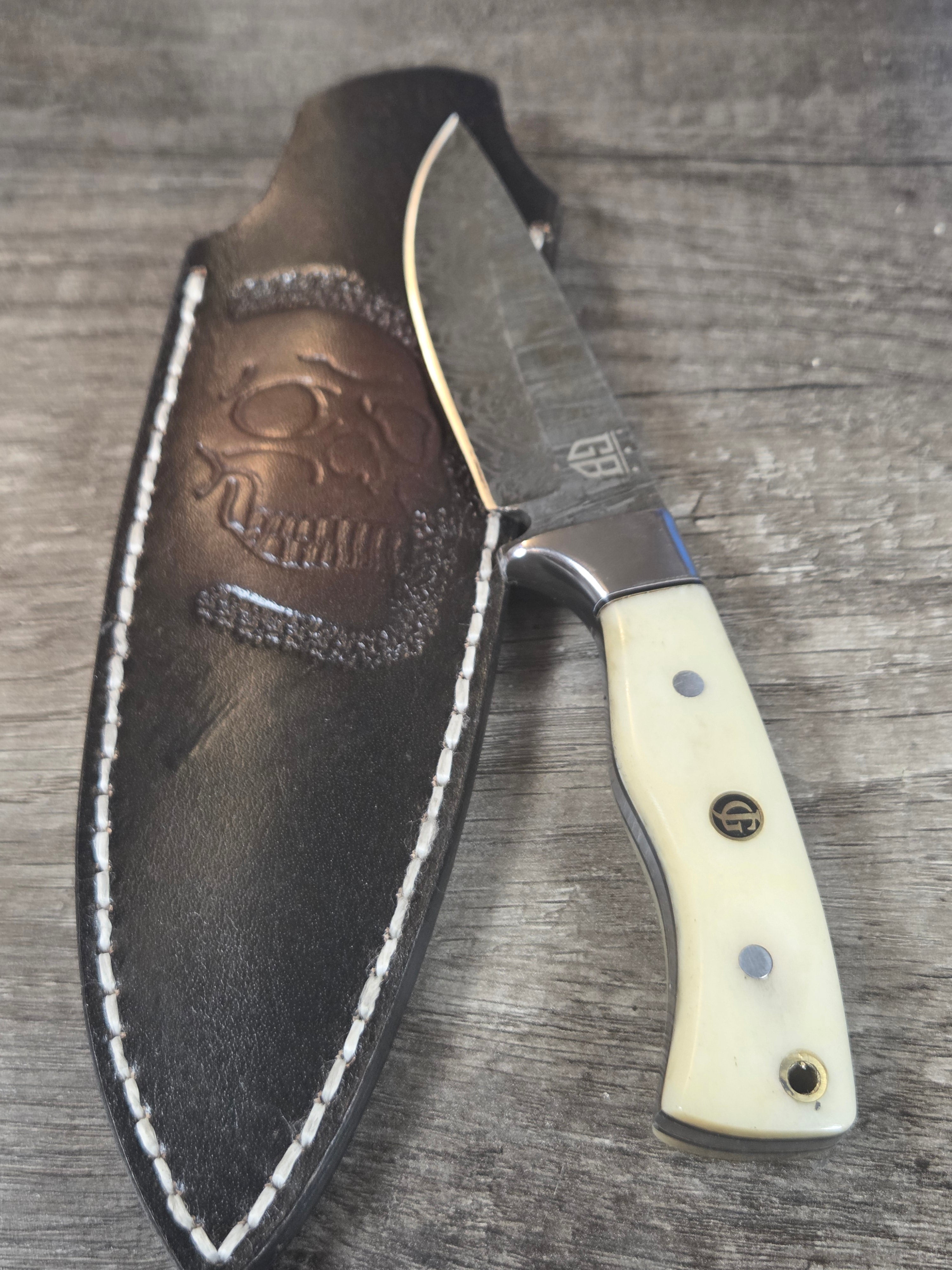 3" 1/2 blade, 8" overall length full tang, Fire damascus with bone handle. Skull sheath